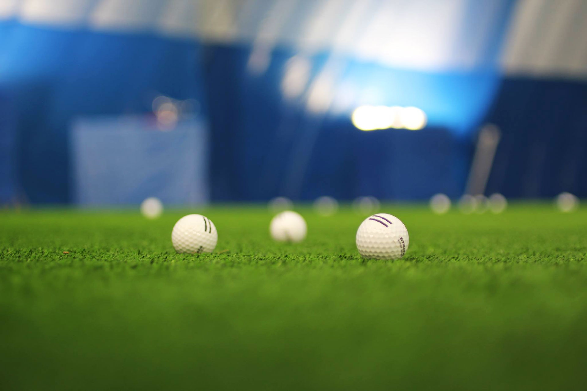 Golf balls on turf at the Braemar Golf Dome
